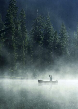 Man canoeing on lake cover with fog poster